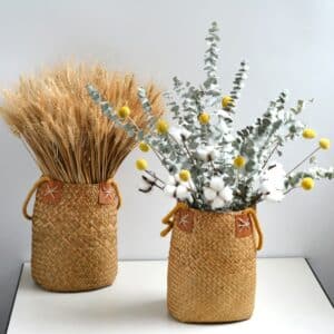 Vase en rotin, tissé avec des fibres de bambou naturelles. Ce vase a le style d'un panier avec deux anses. Il est le contenant idéal pour des fleurs de pampa.