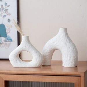 Vase blanc style scandinave en duo. Ces deux vases de forme géométrique abstraite sont conçus dans un style épuré et moderne. Apportez une touche de design en exposant un bouquet de fleurs séchées ou une belle rose en soliflore.